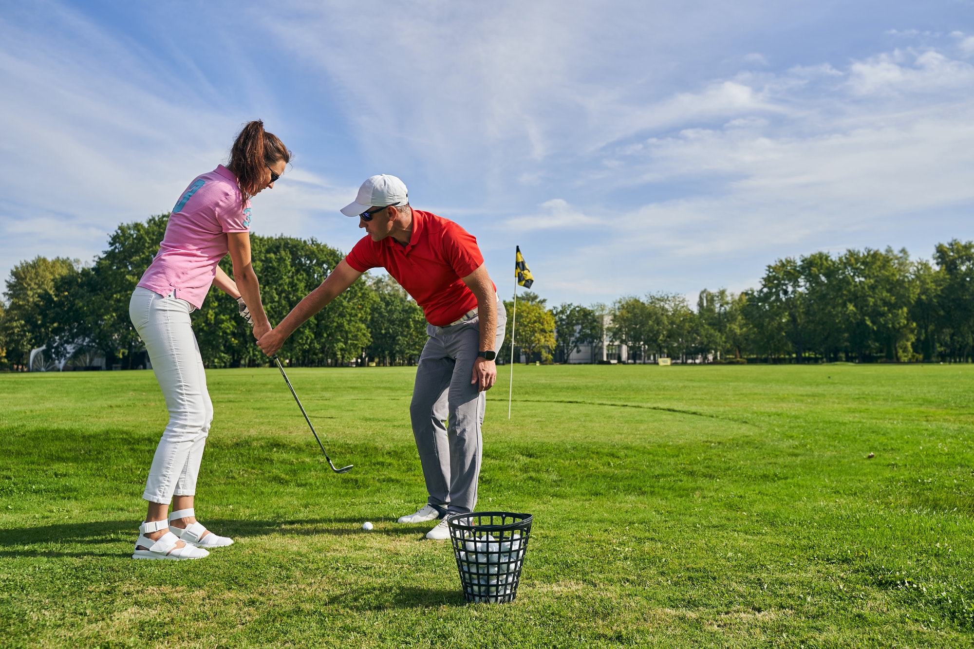 Beginner female golfer learning a proper golf grip